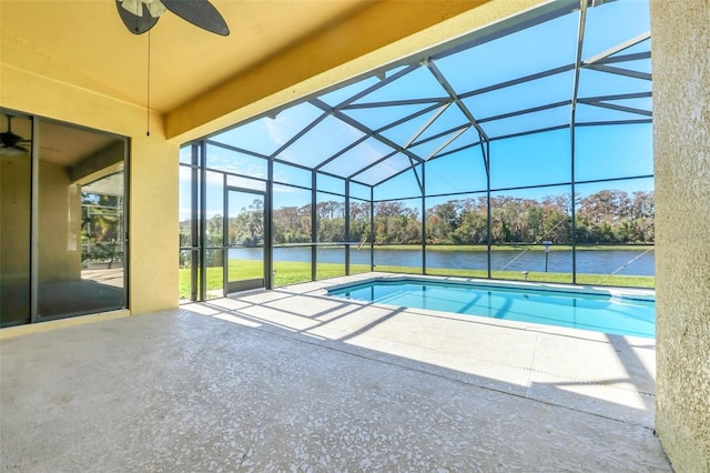 view of swimming pool with a lanai, a water view, a patio area, and ceiling fan