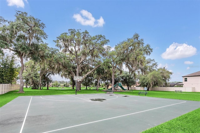 view of basketball court featuring a yard and a playground