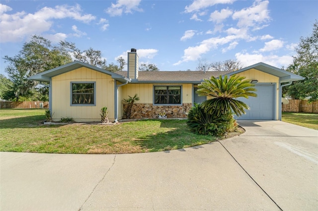 ranch-style house with a garage and a front lawn