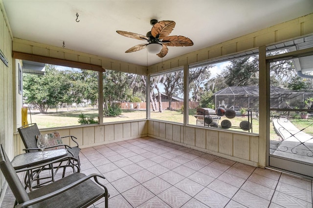 sunroom with ceiling fan and a healthy amount of sunlight