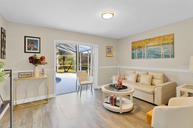 living room featuring a textured ceiling and hardwood / wood-style floors