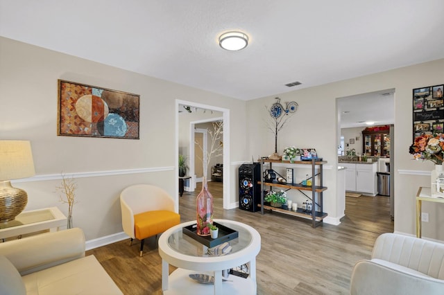 living room with a textured ceiling and hardwood / wood-style flooring