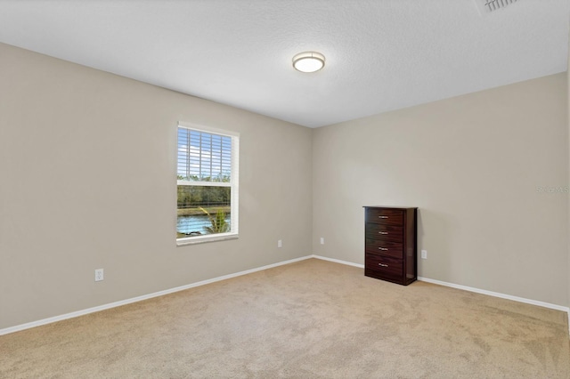 unfurnished room featuring light carpet