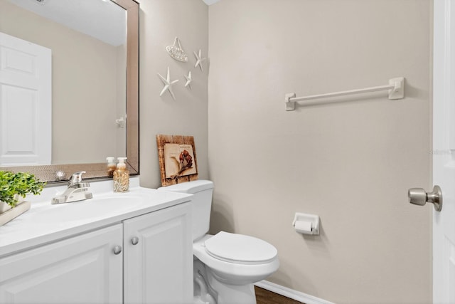 bathroom featuring toilet and vanity