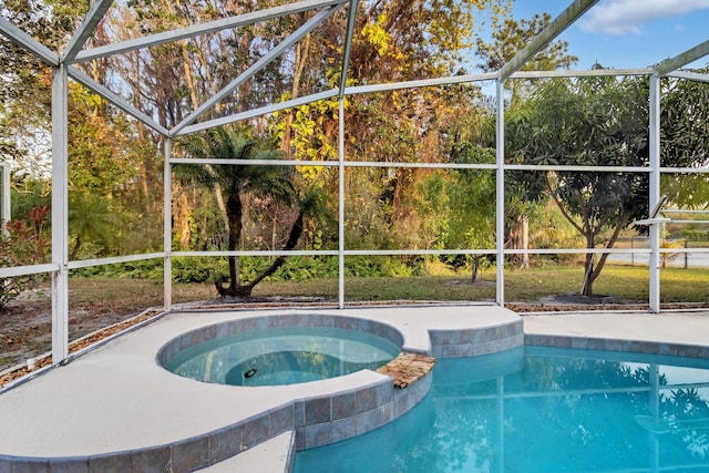 view of swimming pool with glass enclosure and an in ground hot tub