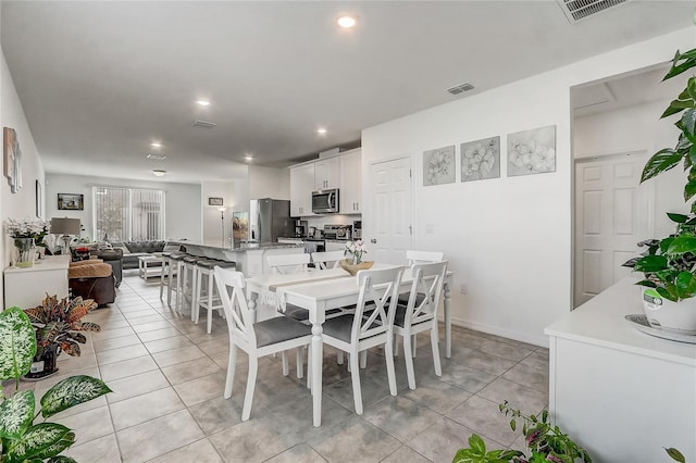 dining space with light tile patterned floors