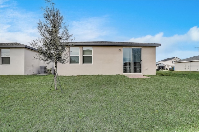 back of property featuring a lawn and cooling unit