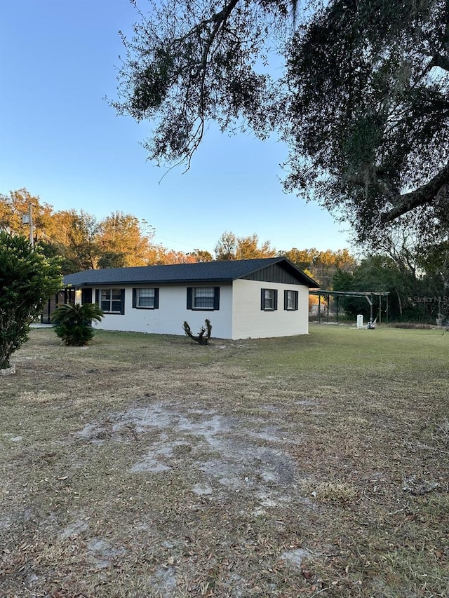 rear view of house featuring a lawn