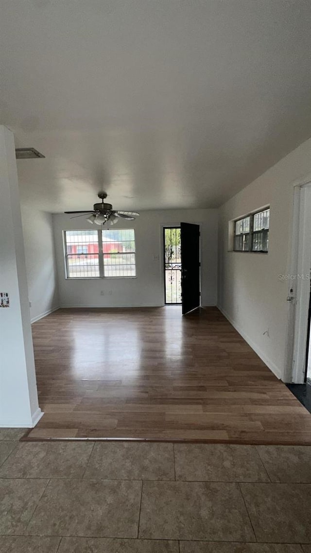 unfurnished room featuring ceiling fan and wood-type flooring