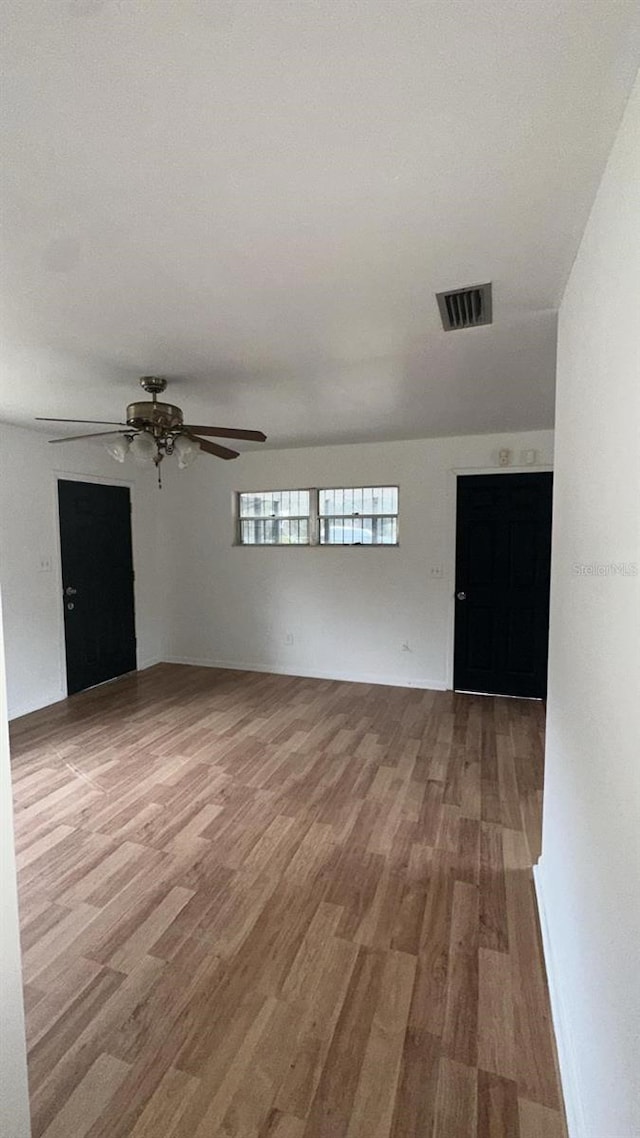 spare room featuring wood-type flooring and ceiling fan