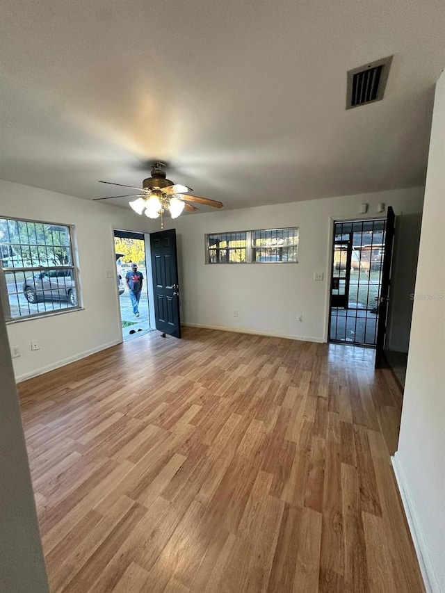 unfurnished room featuring light hardwood / wood-style floors and ceiling fan