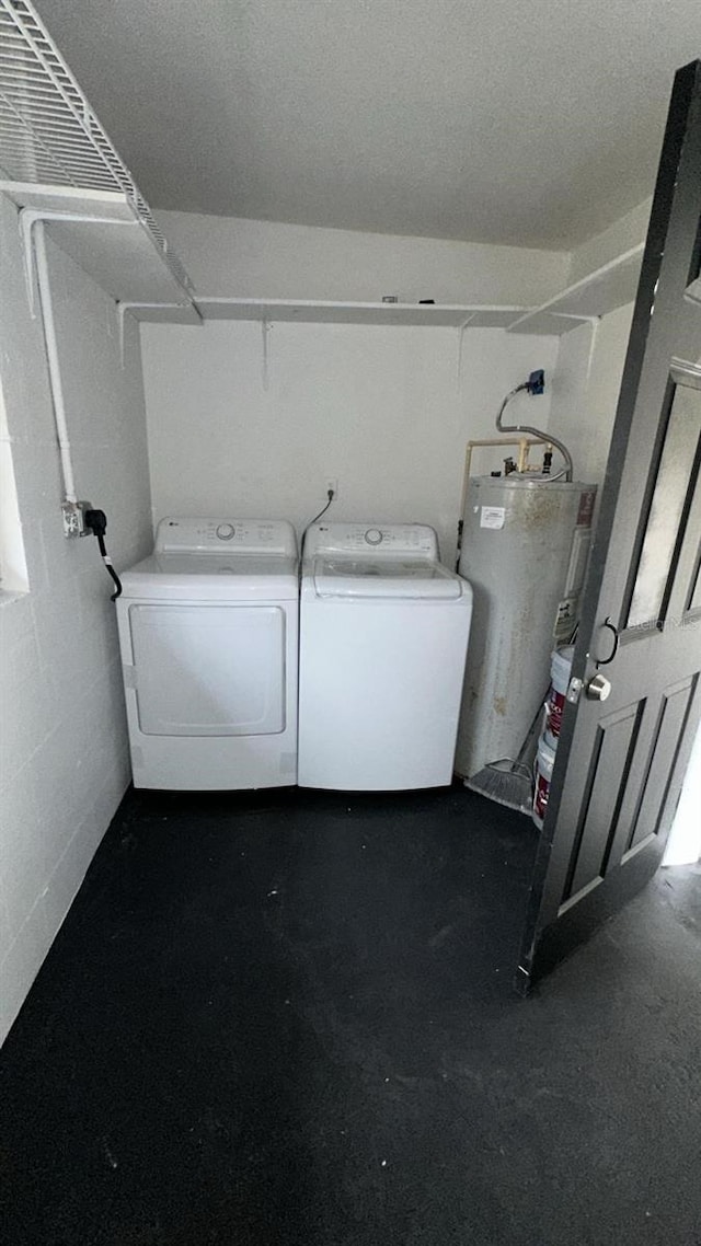 washroom featuring washer and clothes dryer and water heater