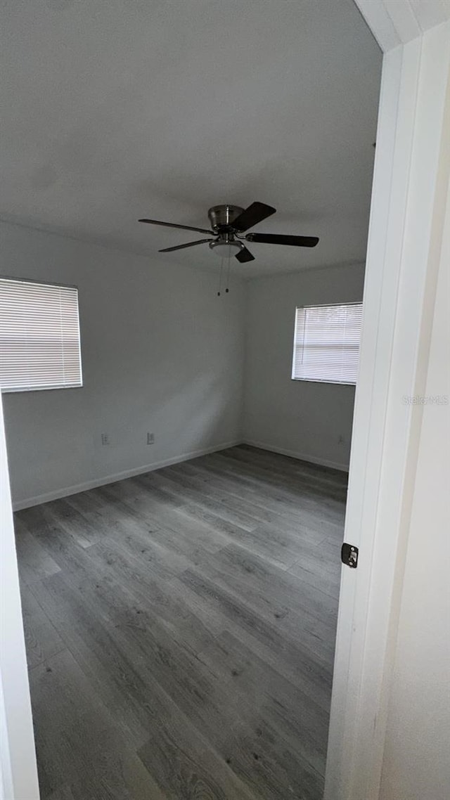 unfurnished room with hardwood / wood-style flooring and ceiling fan