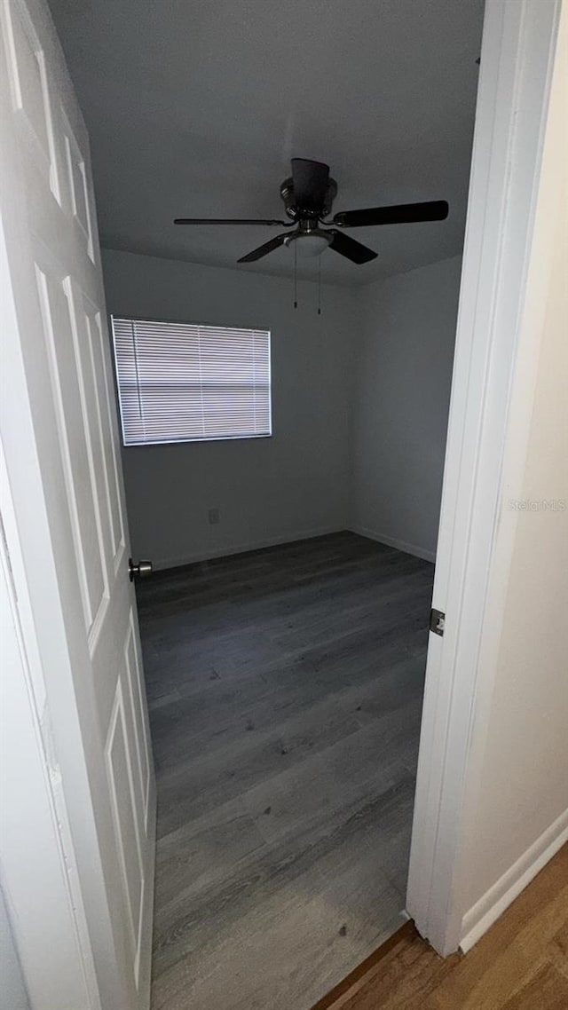 spare room with ceiling fan and dark hardwood / wood-style floors