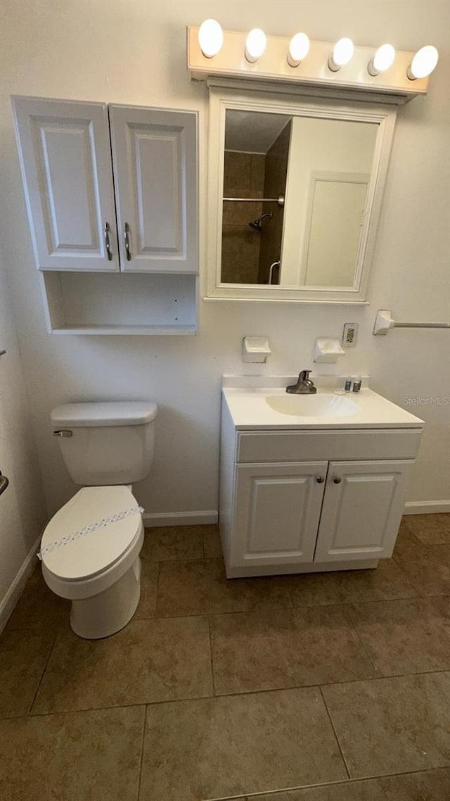 bathroom with vanity, toilet, and tile patterned floors