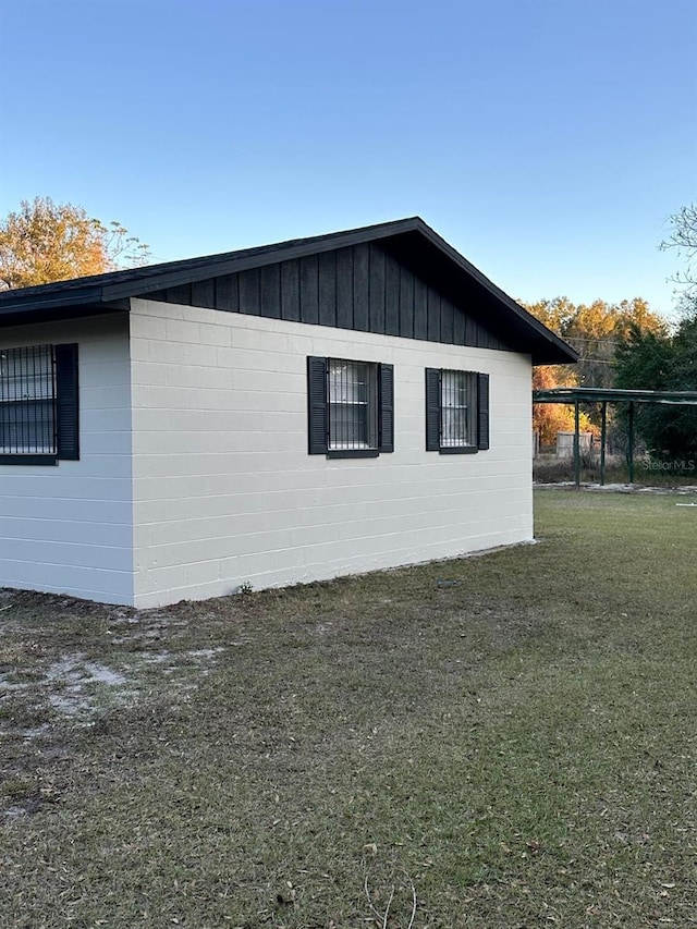 view of property exterior with a lawn