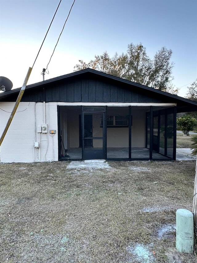 back of house featuring a sunroom