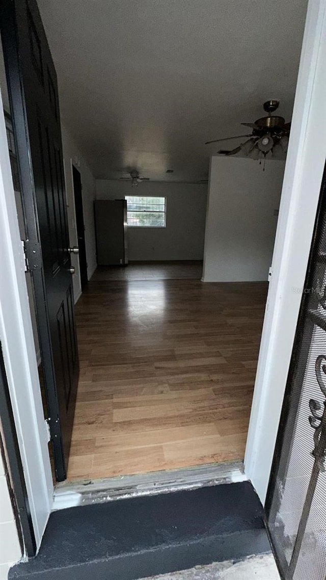 corridor with hardwood / wood-style floors