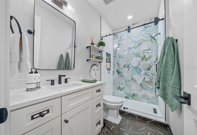 bathroom with vanity, toilet, and a shower with door