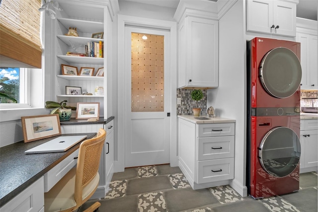 pantry featuring stacked washer and dryer