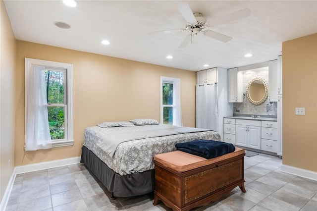 bedroom featuring ceiling fan, sink, and connected bathroom