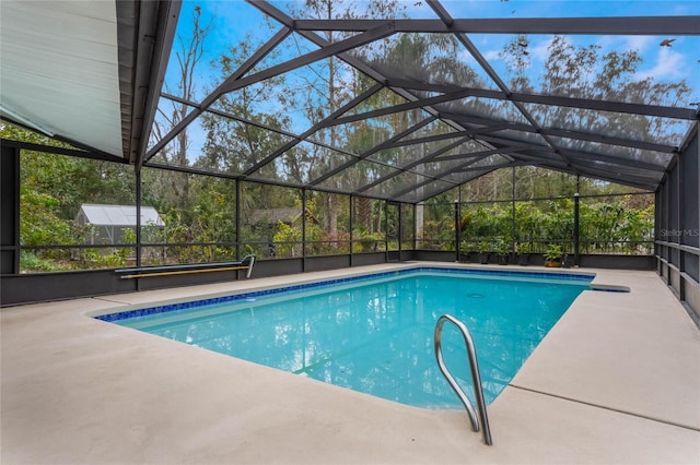 view of swimming pool with a patio and glass enclosure