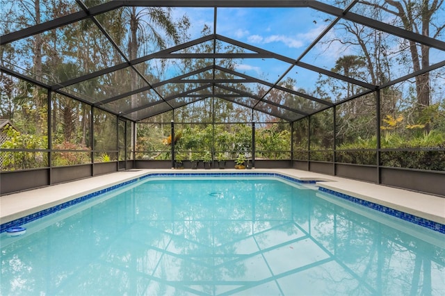 view of pool with glass enclosure