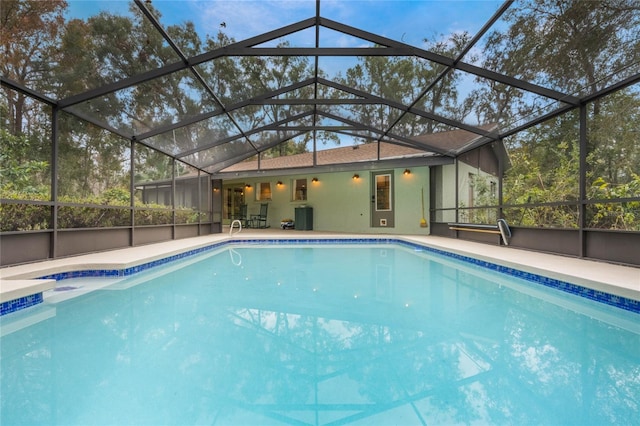 view of pool featuring a patio and glass enclosure