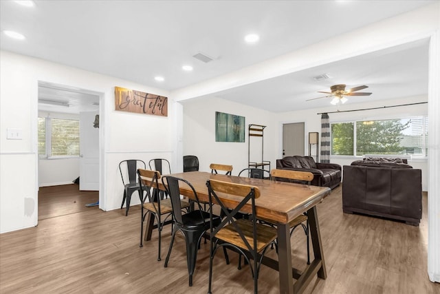 dining room with hardwood / wood-style floors and ceiling fan