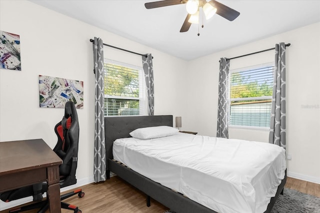 bedroom with wood-type flooring and ceiling fan