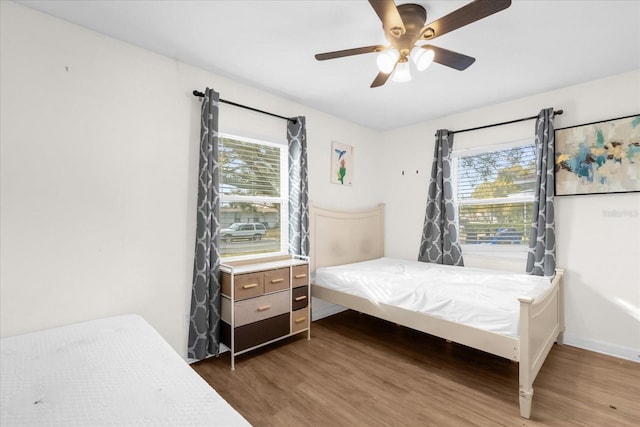 bedroom featuring dark hardwood / wood-style flooring and ceiling fan