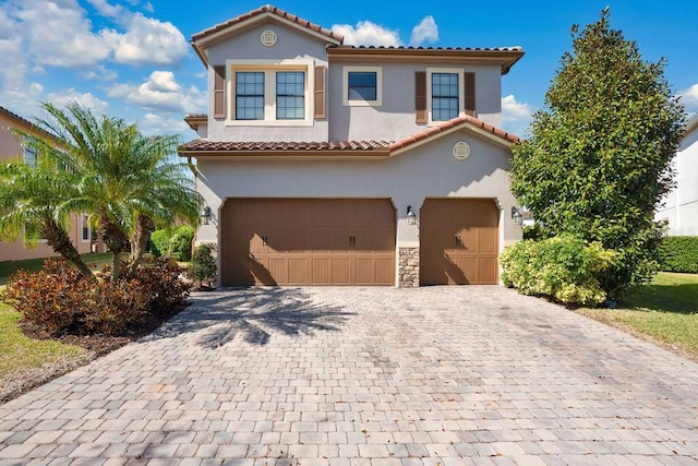 mediterranean / spanish-style home with a garage