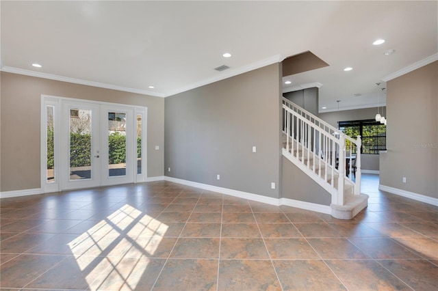 spare room featuring ornamental molding and french doors