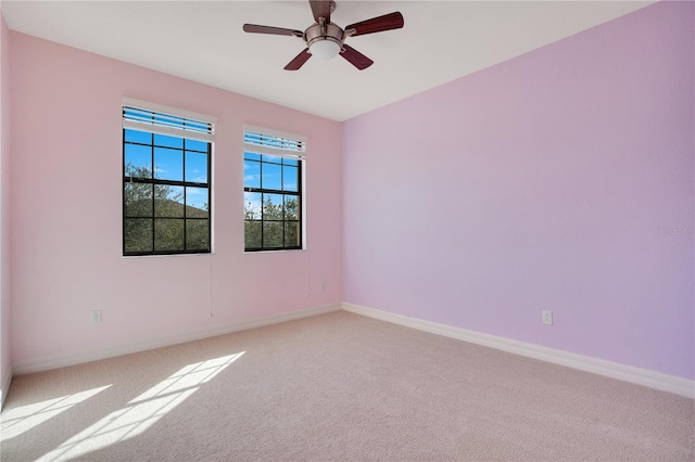 spare room featuring carpet floors and ceiling fan