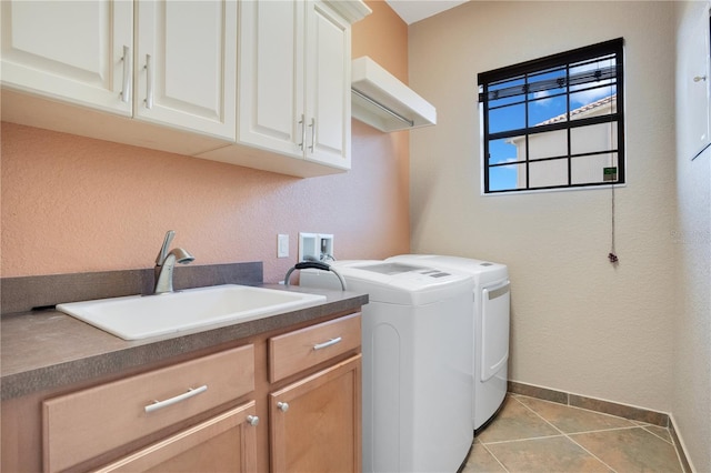 clothes washing area with cabinets, separate washer and dryer, sink, and light tile patterned floors