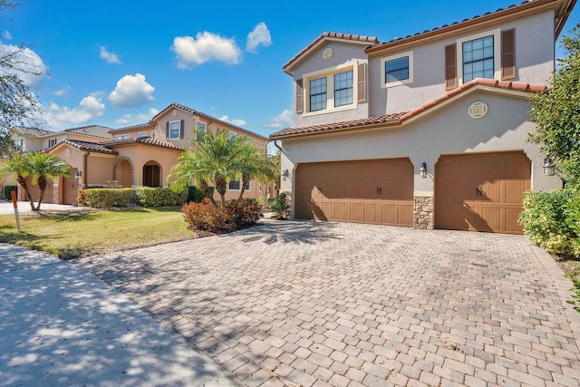 mediterranean / spanish-style house with a garage and a front lawn