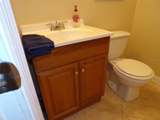 half bath featuring vanity, toilet, and tile patterned floors