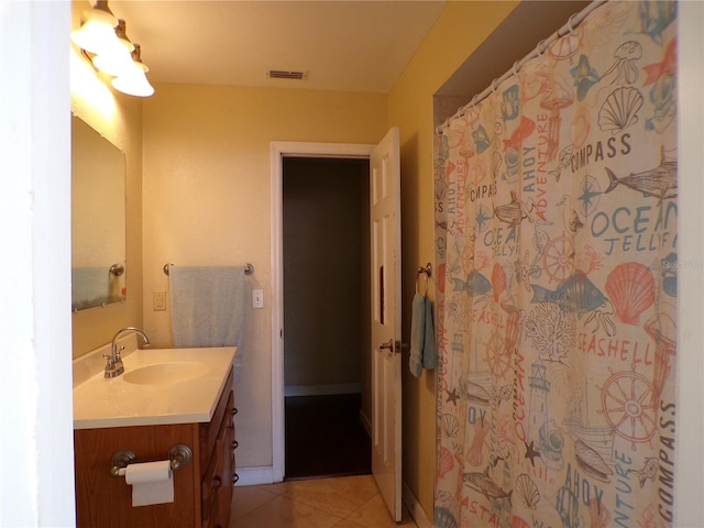 full bathroom featuring visible vents, vanity, baseboards, and tile patterned floors