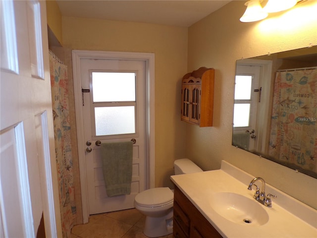 full bathroom with vanity, toilet, and tile patterned floors