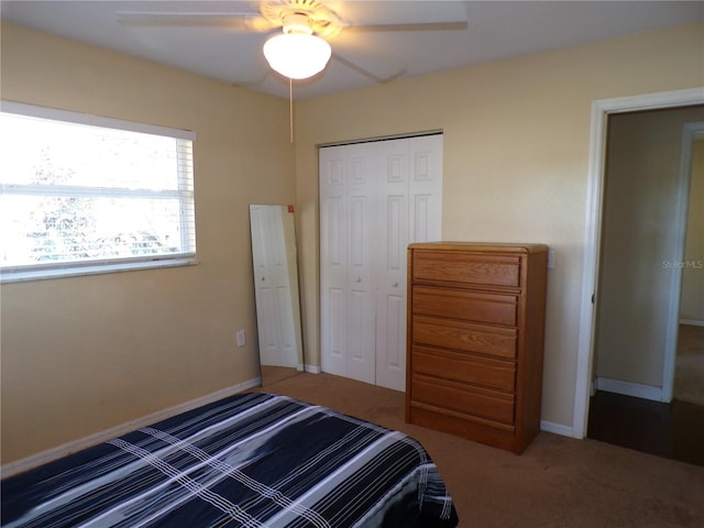 unfurnished bedroom featuring a ceiling fan, carpet, a closet, and baseboards