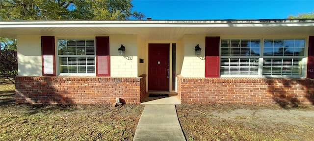 property entrance featuring brick siding