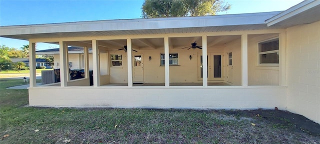 view of patio featuring a ceiling fan and a sunroom