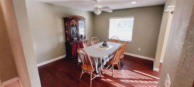 dining area with a ceiling fan, baseboards, and wood finished floors