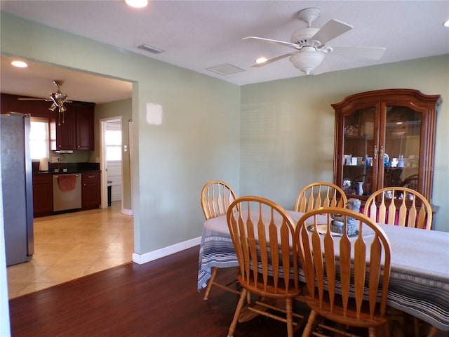 dining room with baseboards, visible vents, a ceiling fan, light wood-type flooring, and recessed lighting