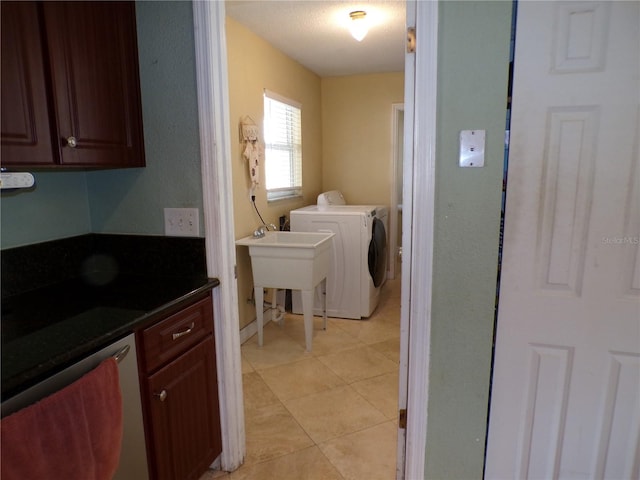 laundry room with laundry area, light tile patterned floors, a sink, and separate washer and dryer