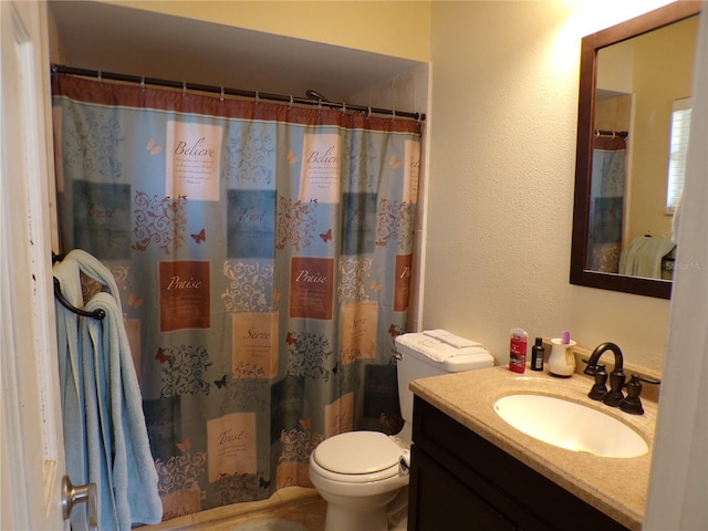 bathroom featuring toilet, a textured wall, curtained shower, and vanity