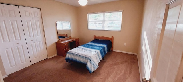 bedroom with carpet floors, a closet, and baseboards