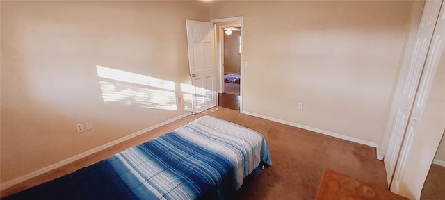 bedroom featuring carpet flooring and baseboards