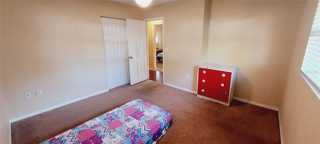 carpeted bedroom featuring baseboards