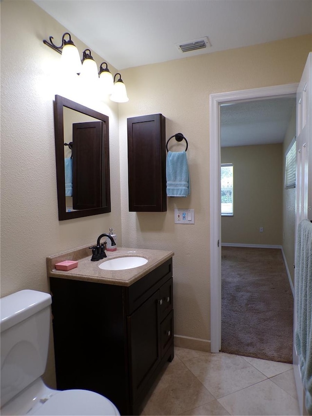 4131 Yorketowne Rd, Orlando, FL 32812 - bathroom featuring vanity, toilet, baseboards, and tile patterned floors